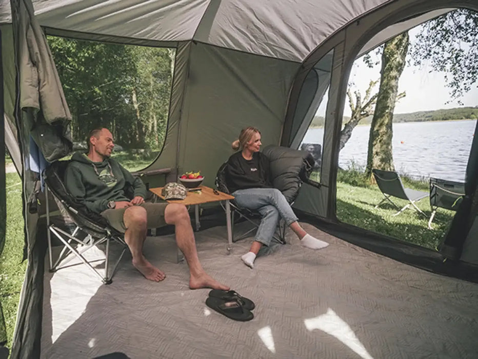 Outwell Armona Campervan Drive Away Awning - lifestyle image, showing couple inside awning