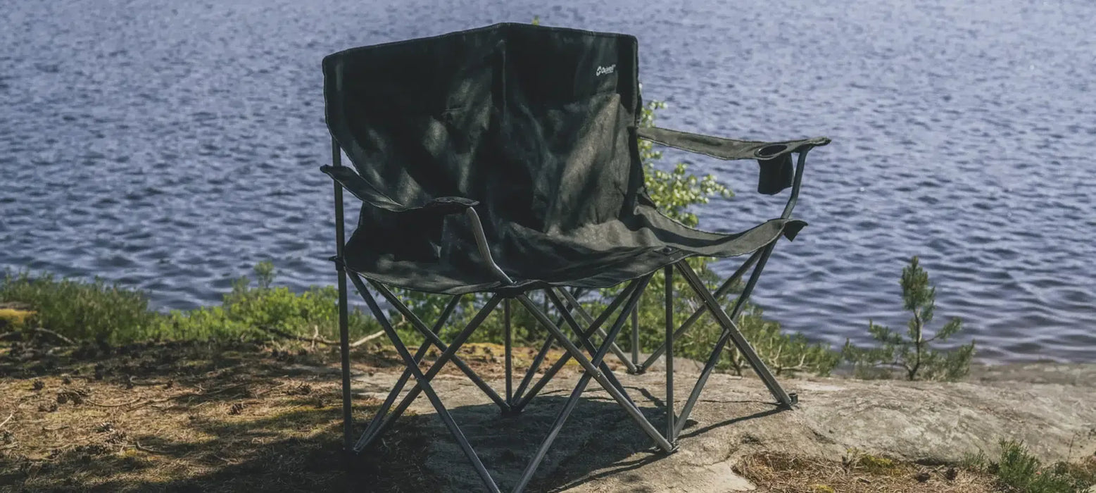 Outwell Catamarca Sofa - 2 Person Camping Chair - lifestyle image, showing sofa outdoors on a lakeside