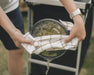 Outwell Collaps Stew Pot 2.5 Litre Camping Cooking Pot - lifestyle image, showing person draining water from cooking pot