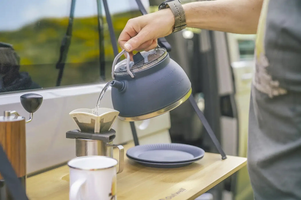 Outwell Collaps Tea Time 1.5L Collapsible Camping Kettle - lifestyle image, showing person pouring water from kettle into coffee pot