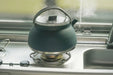 Outwell Collaps Tea Time 1.5L Collapsible Camping Kettle - lifestyle image, showing kettle boiling on camping stove