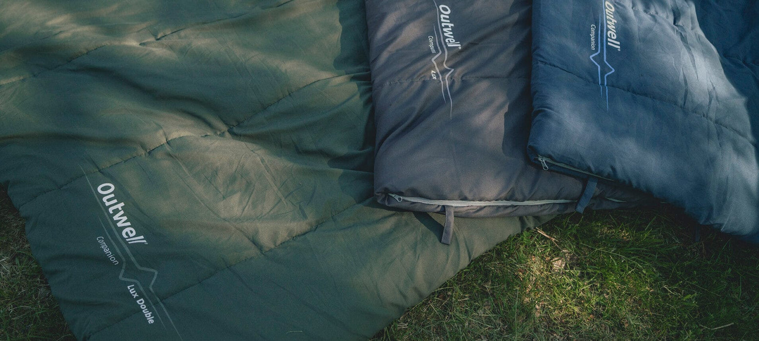Outwell Companion Sleeping Bag - Blue - shown alongside black Companion Lux and green Lux Double models for comparison