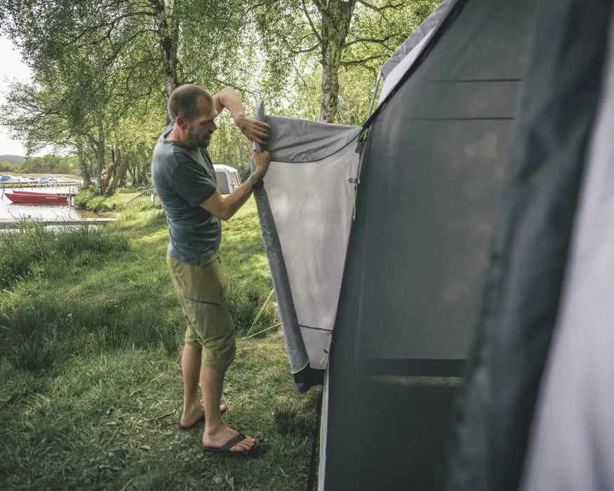 Outwell Dakota Freestanding Outdoor Camping Shelter - lifestyle image, showing person rolling side door open