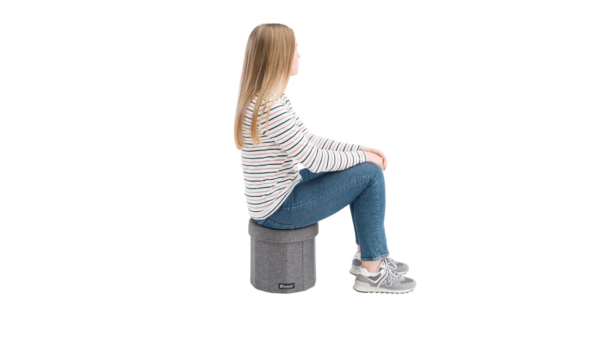 Outwell Dawlish Seat & Storage Box lifestyle image showing woman using as a stool