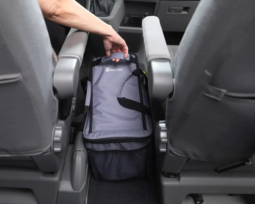 Outwell Eagle Van Cooler 15 Litre Camping Cool Bag - lifestyle image, showing person reaching for handle of cool bag placed between seats inside a vehicle