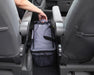 Outwell Eagle Van Cooler 15 Litre Camping Cool Bag - lifestyle image, showing person reaching for handle of cool bag placed between seats inside a vehicle