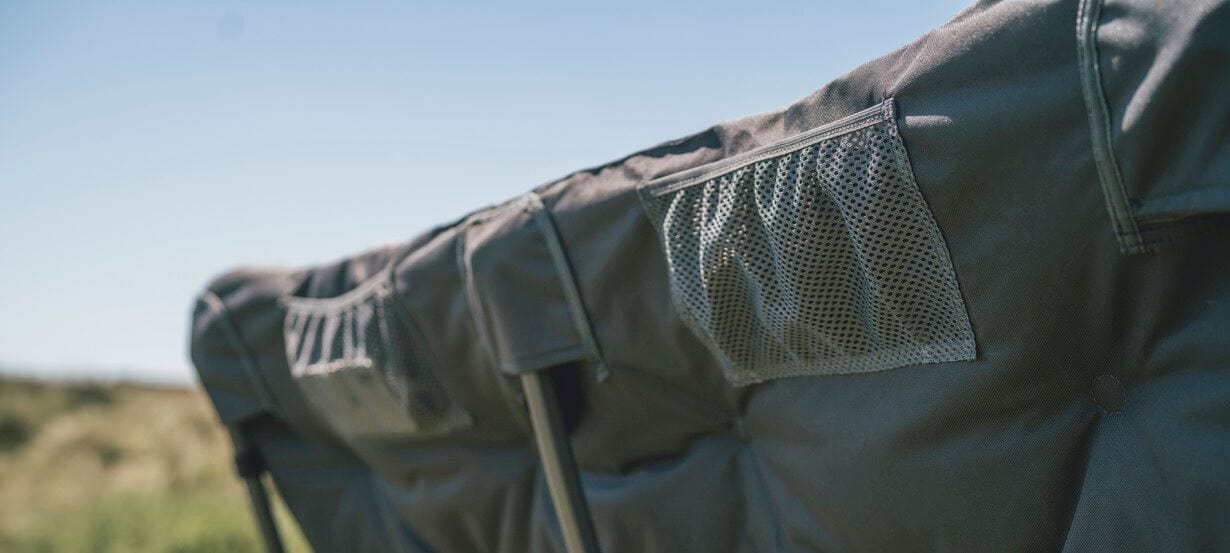 Outwell Fremont Lake Sofa 2-Seater Chair - close-up of product rear storage pockets, shown outdoors