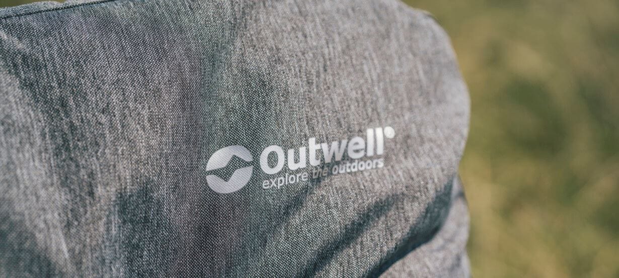 Outwell Fremont Lake Sofa 2-Seater Chair - close-up of product material and Outwell logo, shown outdoors