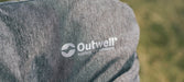 Outwell Fremont Lake Sofa 2-Seater Chair - close-up of product material and Outwell logo, shown outdoors
