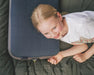 Outwell Memory Air Deluxe Camping Pillow - lifestyle image, showing child laying on pillow