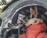 Outwell Nexion 2 - Instant Pitch 2-Person Pop-Up Tent - lifestyle image, showing woman sat up in sleeping bag reading a book