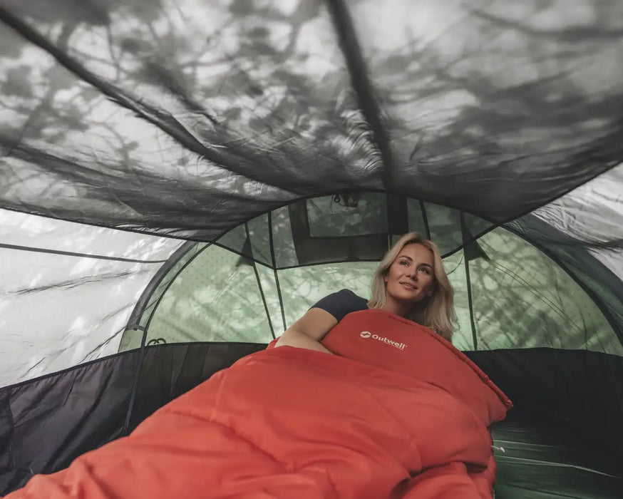 Outwell Nexion 3 - Instant Pitch 3-Person Pop-Up Tent - lifestyle image, showing woman in sleeping bag inside tent