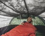 Outwell Nexion 3 - Instant Pitch 3-Person Pop-Up Tent - lifestyle image, showing woman in sleeping bag inside tent