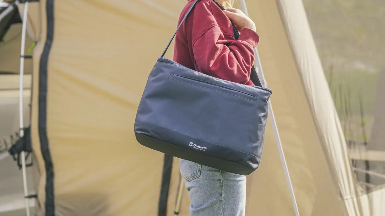 Outwell Petrel 20 Litre Camping Cool Bag - lifestyle image, showing person carrying cool bag over their shoulder by the shoulder strap