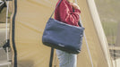 Outwell Petrel 20 Litre Camping Cool Bag - lifestyle image, showing person carrying cool bag over their shoulder by the shoulder strap