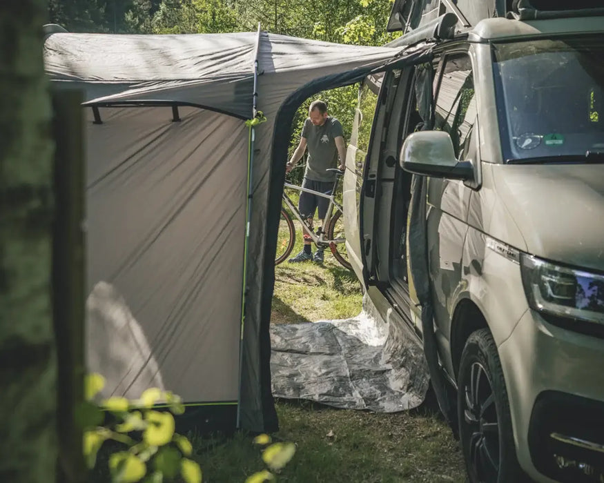 Outwell Pine Hills Drive Away Campervan Awning - lifestyle image, showing awning connected to vehicle with tunnel doors open