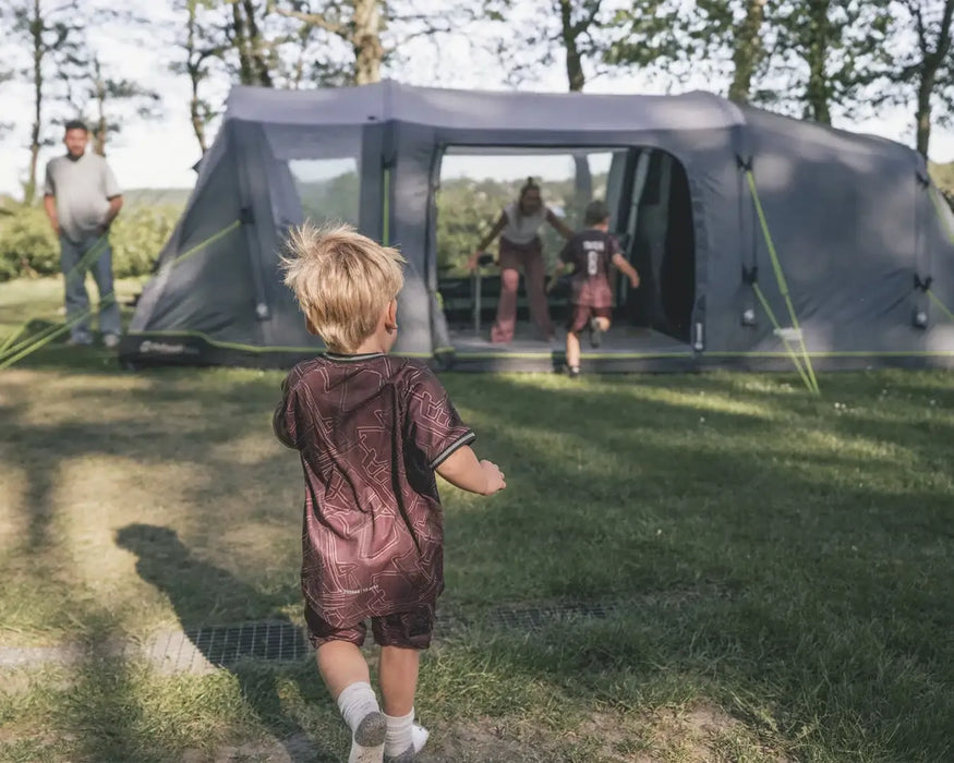 Outwell Sacramento 6 Air Inflatable 6 Person Tent - lifestyle image, showing parents and children with tent
