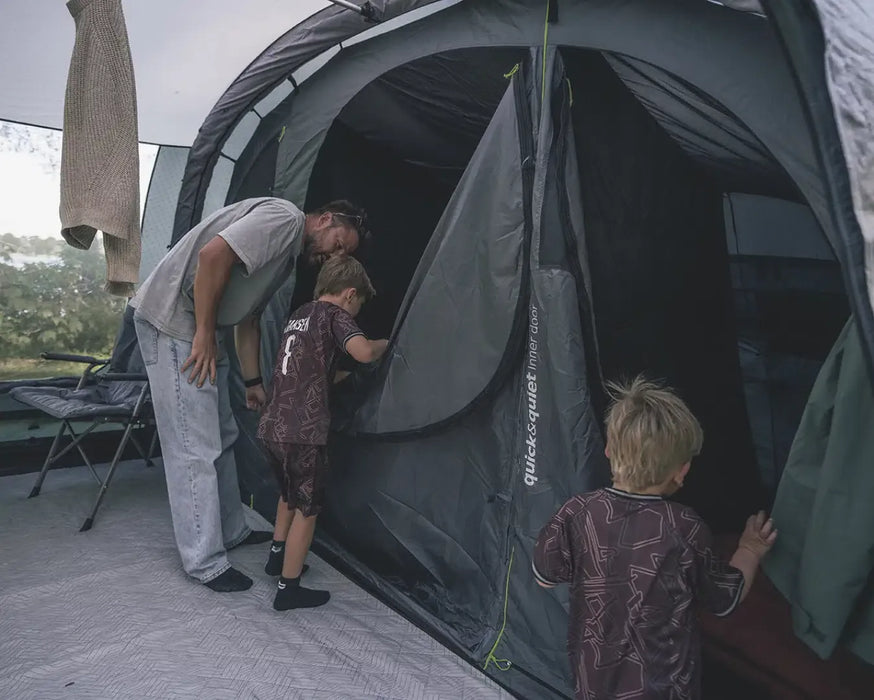 Outwell Sacramento 6 Air Inflatable 6 Person Tent - lifestyle image, showing parent and children at tent inner door