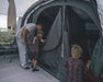 Outwell Sacramento 6 Air Inflatable 6 Person Tent - lifestyle image, showing parent and children at tent inner door