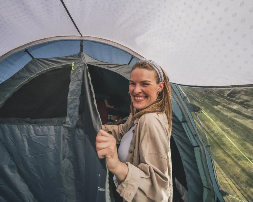 Outwell Sky 6 Person Tunnel Family Tent - lifestyle image, showing woman entering tent bedroom