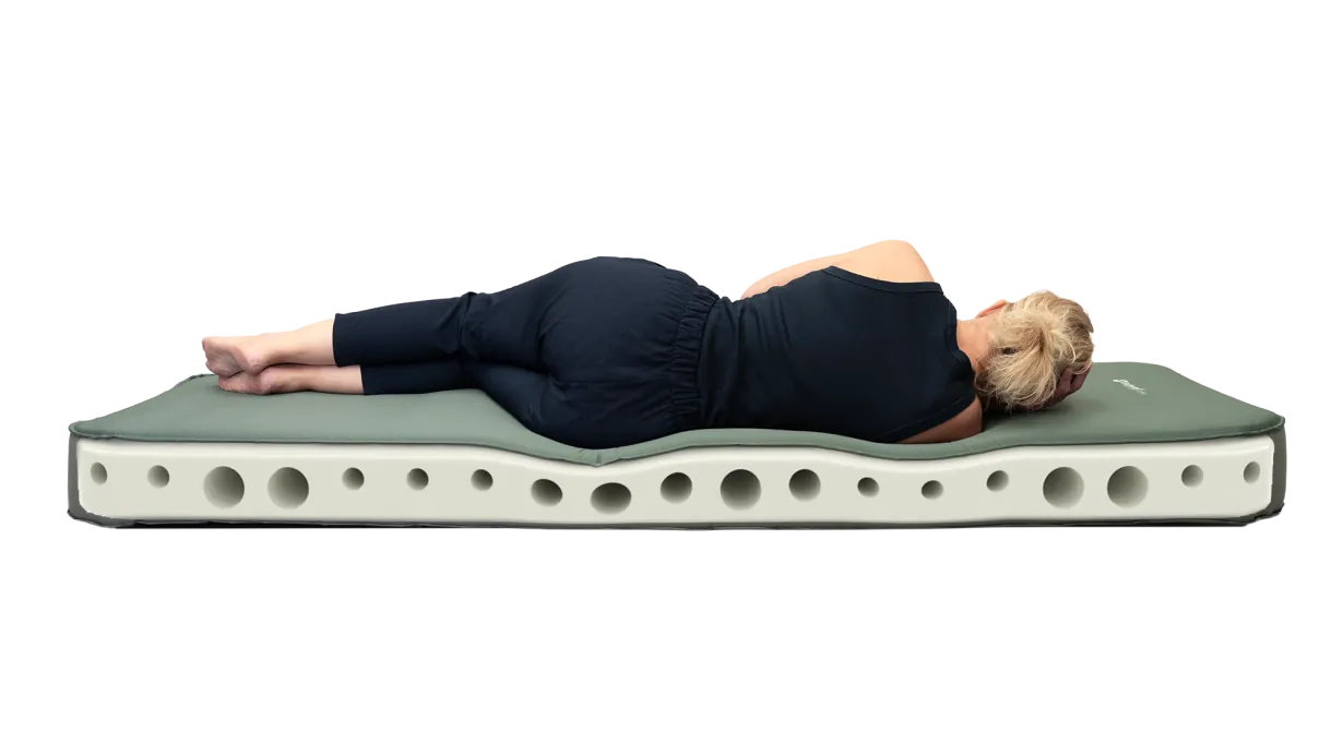 Outwell Sleepnest Double Deluxe Self Inflating Camping Mat - product image, showing person lying on mattress, with representation of internal material