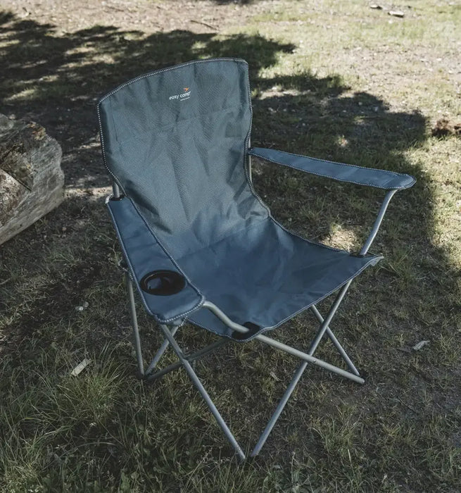 Outwell Spruce Folding Camping Chair - Fjord Blue - lifestyle image, showing chair outdoors