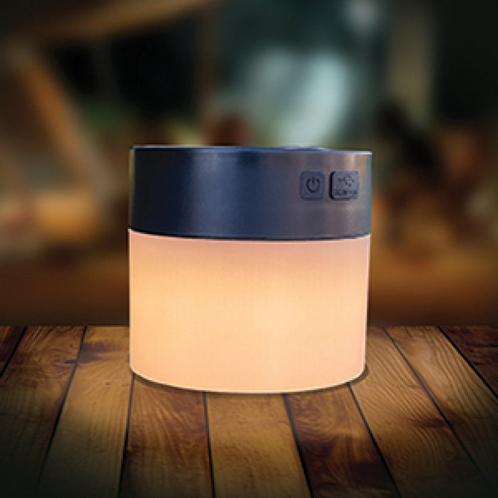 PLS Rechargeable Universal Windbreak LED Solar Light - lifestyle image, showing close-up of light emitting warm white light, sat on wooden tabletop