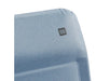 Travellife Lago Recliner Comfort Chair Wave Blue - product image, showing a close-up of a light blue textured fabric product, likely a chair or cushion, with a small black square logo patch containing white letters on the upper right side, set against a plain white background.