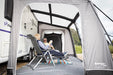Vango Balletto Air 390 Inflatable Caravan Porch Awning - 2026 Model - lifestyle image, showing couple inside awning attached to caravan