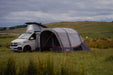 Vango Cove Air TC Inflatable Drive Away Awning Grey - Low  lifestyle image of awning pitched against pop top VW with all doors zipped up. 