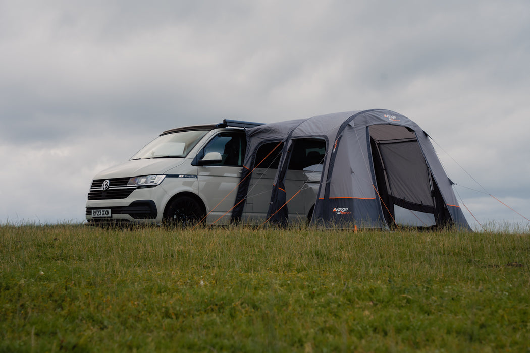Vango Faros III Air Inflatable Drive Away Awning Cloud Grey - Low lifestyle image with all doors unzipped. awning attached to van and vent open on right side