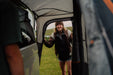 Vango Faros III Air Inflatable Drive Away Awning Cloud Grey - Low lifestyle image of woman in rear cowl door smiling