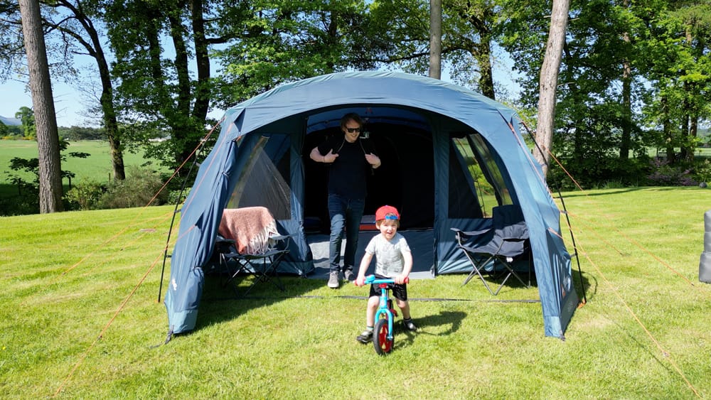 Vango Savannah 600XL 6-Person Family Tent Package - lifestyle image, showing adult and child inside tent entrance