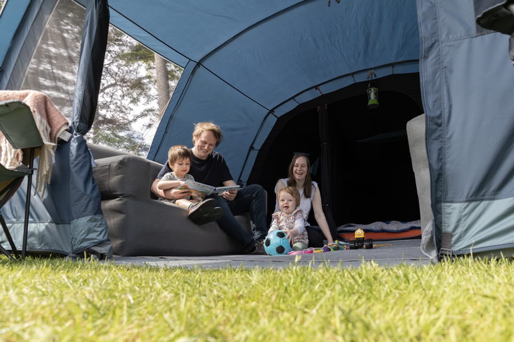Vango Savannah 600XL 6-Person Family Tent Package - lifestyle image, showing family sat inside tent