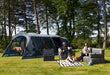 Vango Savannah 600XL 6-Person Family Tent Package - lifestyle image, showing family sat on inflatable furniture in front of pitched tent