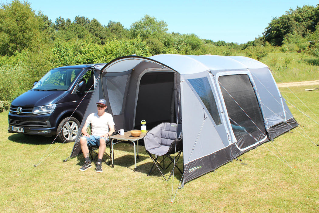 Outdoor Revolution Cacos Air SL Mid Driveaway Awning lifestyle image of front of awning with door open to interior with table and chair in canopy 