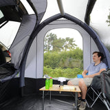 Kampa Travel Pod Tailgater Car Drive-Away Tent - Air beam - man sat inside at table internal view