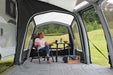 Outdoor Revolution Eclipse Pro Annexe interior view attached to awning showing use as conservatory with example chair and table inside and window half open