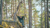 Robens Trace Hammock Chair - Lightweight Adventure Chair lifestyle image of person in hammock  surrounded by trees