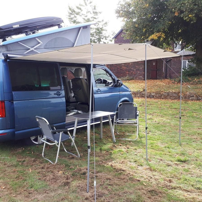 Sunncamp Sunnshield 240 Van Canopy - pitched onto blue van with example table and chairs outside