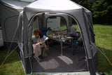 Vango Airhub Hexaway II Drive Away Awning - Tall - Lifestyle image showing family inside awning