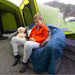Vango Inflatable Sofa - Nutmeg showing example use of the sofa on a campsite with boy sat on sofa