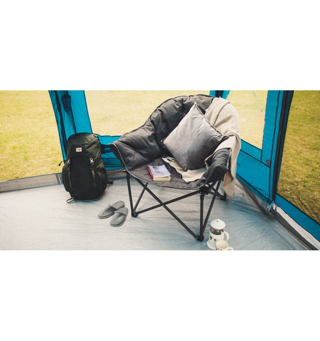 Vango Titan 2 Oversized Padded Chair lifestyle  image of chair in tent with throw and cushion